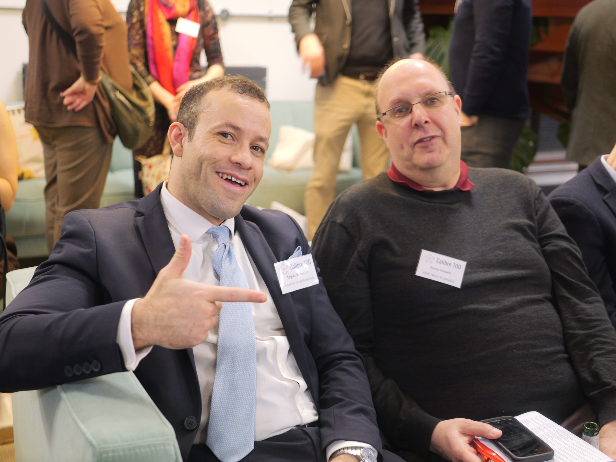 Taylor Wheeler in conversation with a fellow founder at Calibre 100
